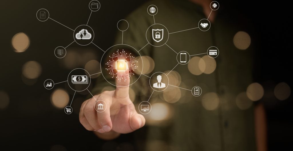 Person interacting with a futuristic artificial intelligence interface with icons for cloud computing, security, finance, and communication, highlighting an AI chip.