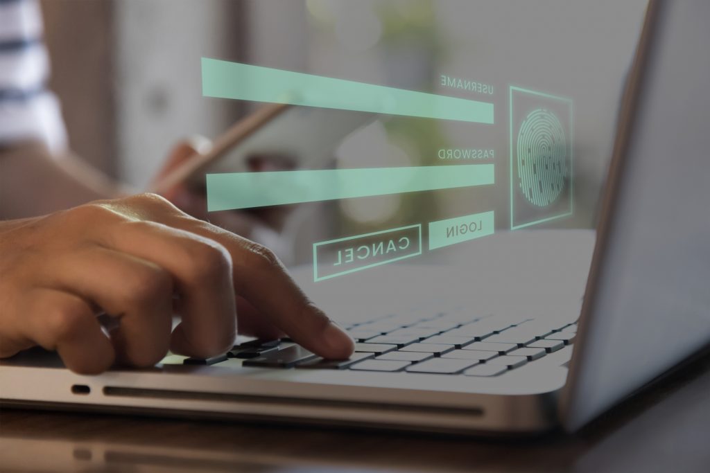 A laptop with a login screen pop-up, representing the need for zero trust approaches to container network security